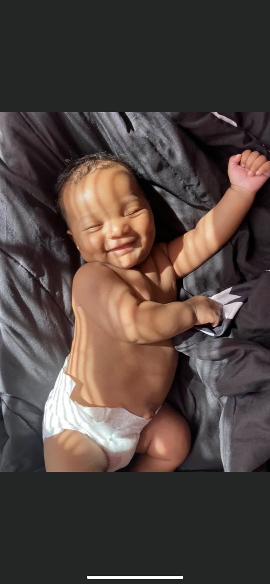 Smiling baby in Cymone's care